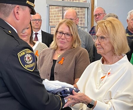 Mary Berman accepts American Flag from Kane County Sherriff's Honor Guard