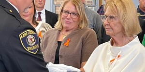 Mary Berman accepts American Flag from Kane County Sherriff's Honor Guard