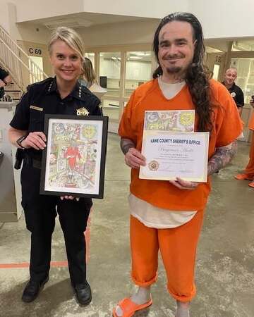 Kane County Undersheriff Amy Johnson with winning artwork 