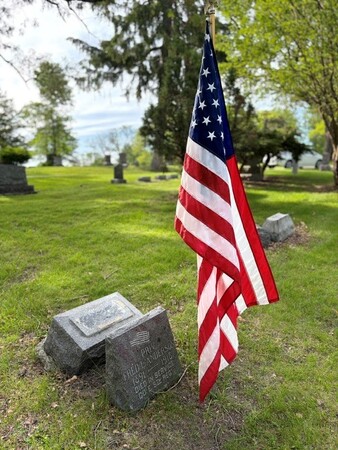 Flag posted at grave of fallen solider from Geneva Township