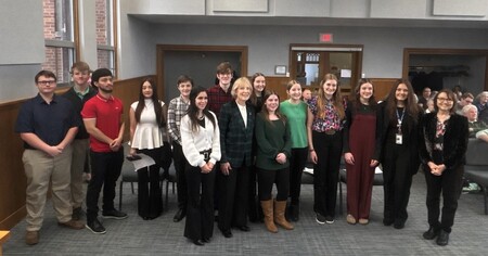 Group of 4H members in the Kane County Board room with various officlas 
