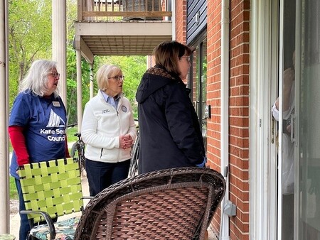 Kane County Board Chairman Corinne Pierog and Volunteer Nancy talk with Meals on Wheel client