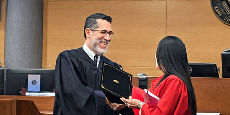 Kane County Judge Rene Cruz congratulates one of three recent graduates of Kane County’s DUI Treatment Court during a ceremony at the courthouse.