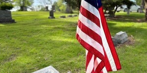 Flag posted at grave of fallen solider from Geneva Township