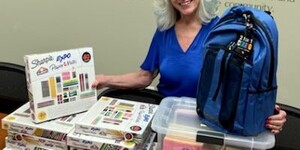 Kane County Regional Superintendent Patricia Dal Santo shows some of the new school supplies that ROE has to help Kane County students have a successful school experience. Photo credit: Kane County ROE