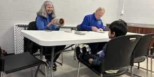 Aurora Lions Club members Susan Koepke, left, and Jay Short screen a youth's vision in January at Fox Valley Park District's Eola Community Center. A total of 178 children were screened in two months. (FVPD photo)