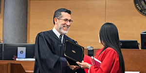 Kane County Judge Rene Cruz congratulates one of three recent graduates of Kane County’s DUI Treatment Court during a ceremony at the courthouse.